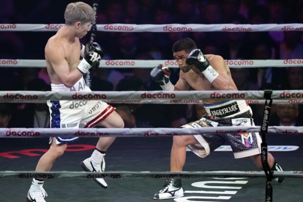 Naoya Inoue of Japan, left, and Marlon Tapales of the Philippines, right, fight in the first round of their boxing match for the unified WBA, WBC, WBO and IBF super bantamweight world titles in Tokyo, Tuesday, Dec. 26, 2023