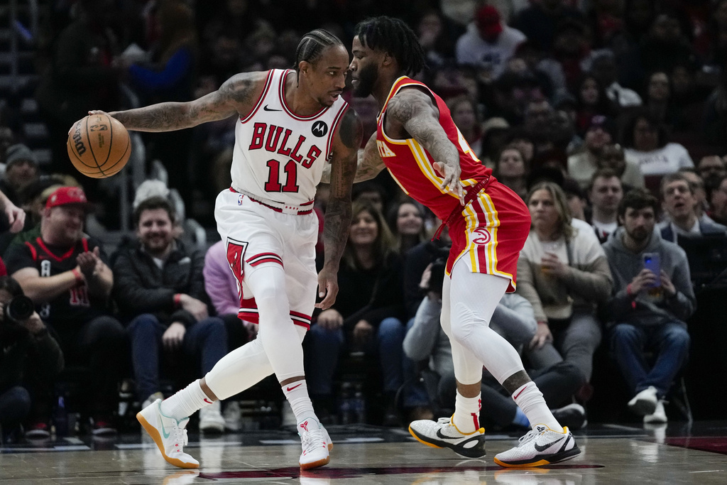 Chicago Bulls forward DeMar DeRozan, left, is guarded by Atlanta Hawks forard Saddiq Bey during the first half of an NBA basketball game Tuesday, Dec. 26, 2023, in Chicago. 