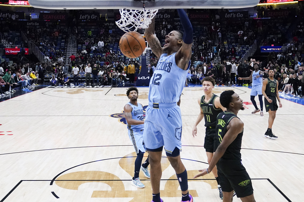 Memphis Grizzlies guard Ja Morant slam dunks in the final seconds of overtime during an NBA basketball game against the New Orleans Pelicans in New Orleans, Tuesday, Dec. 26, 2023. The Grizzlies won 116-115. 