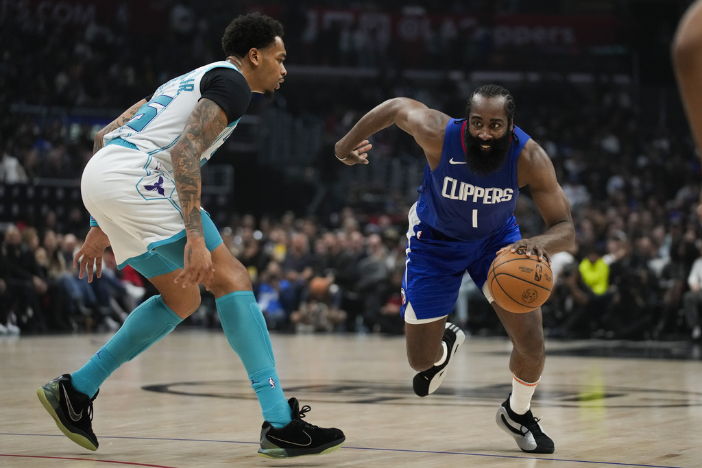 Charlotte Hornets forward P.J. Washington (25) defends against Los Angeles Clippers guard James Harden (1) during the first half of an NBA basketball game in Los Angeles, Tuesday, Dec. 26, 2023. 