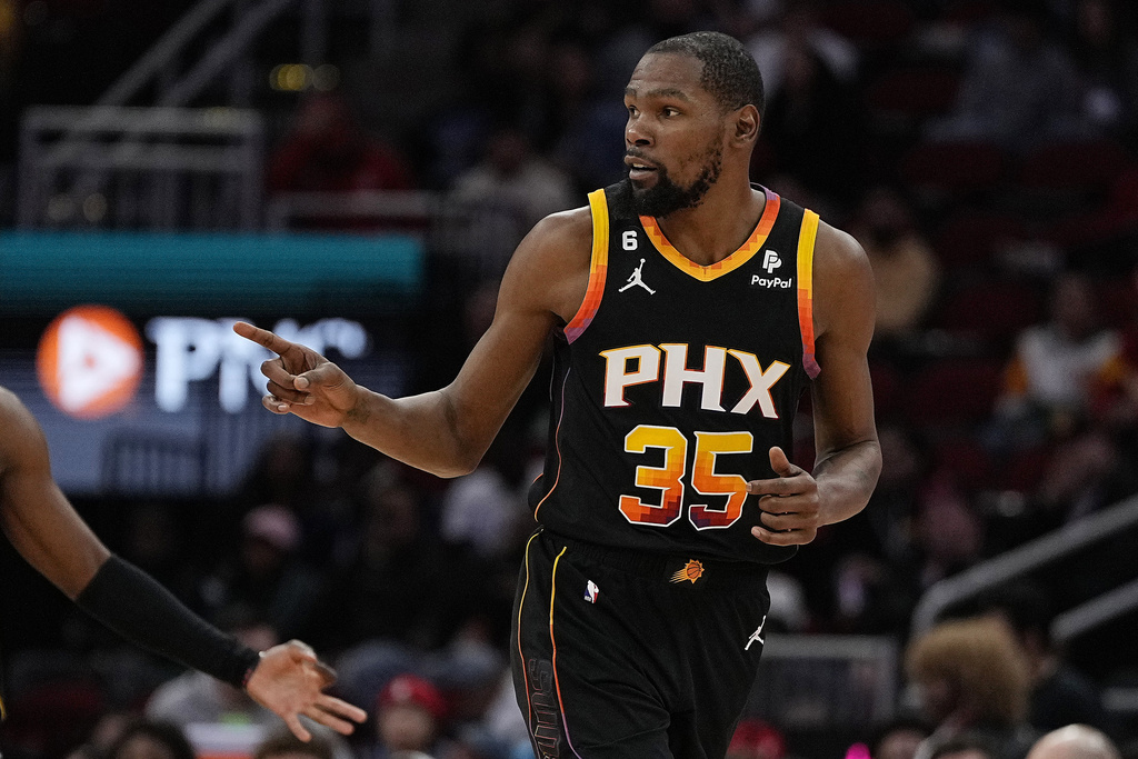 Phoenix Suns forward Kevin Durant celebrates after hitting a 3-pointer against the Houston Rockets during the fourth quarter of an NBA basketball game Wednesday, Dec. 27, 2023, in Houston.