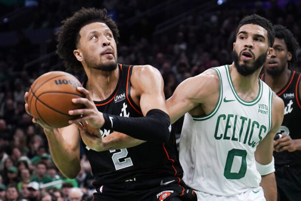 Detroit Pistons guard Cade Cunningham (2) drives to the basket against Boston Celtics forward Jayson Tatum (0) during the first half of an NBA basketball game, Thursday, Dec. 28, 2023, in Boston