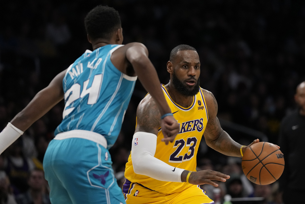 Charlotte Hornets forward Brandon Miller (24) defends against Los Angeles Lakers forward LeBron James (23) during the second half of an NBA basketball game in Los Angeles, Thursday, Dec. 28, 2023.