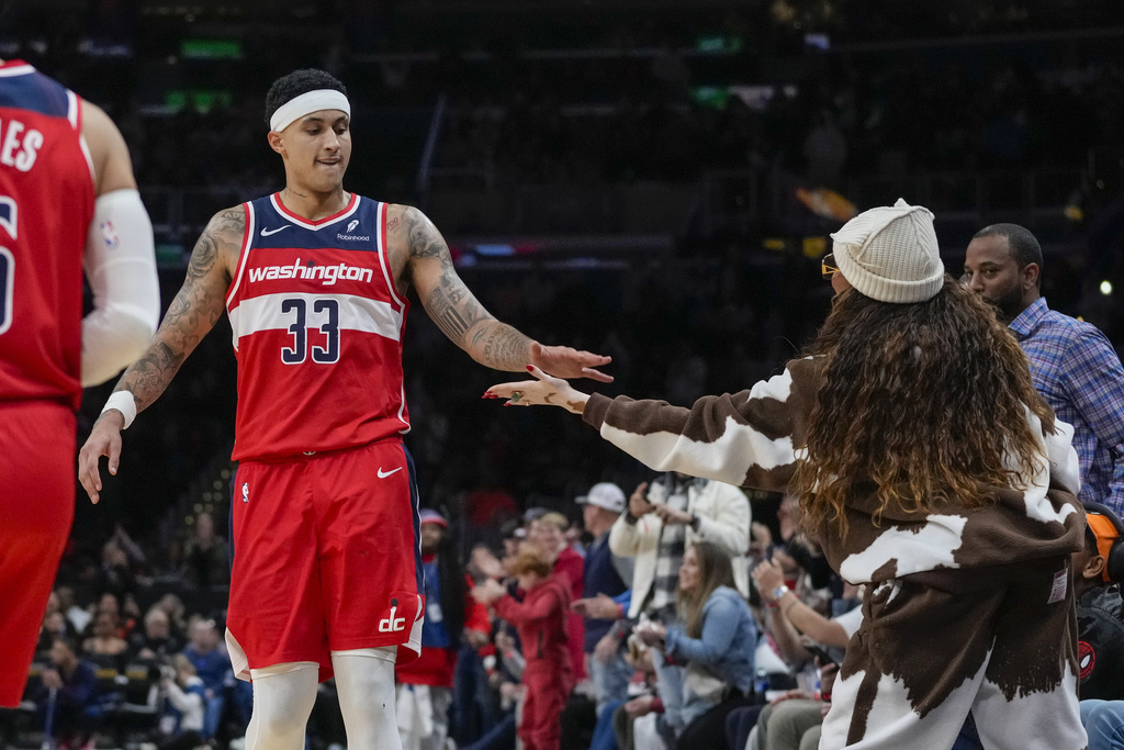 Washington Wizards forward Kyle Kuzma (33) celebrates with his girlfriend, Winnie Harlow, during the second half of the team's NBA basketball game against the Brooklyn Nets, Friday, Dec. 29, 2023, in Washington. 
