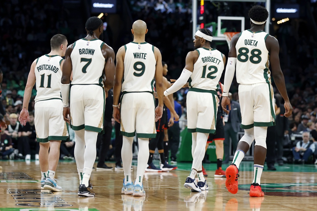 Boston Celtics' Payton Pritchard (11), Jaylen Brown (7), Derrick White (9), Oshae Brissett (12) and Neemias Queta (88) during the second half of an NBA basketball game against the Toronto Raptors, Friday, Dec. 29, 2023, in Boston. 