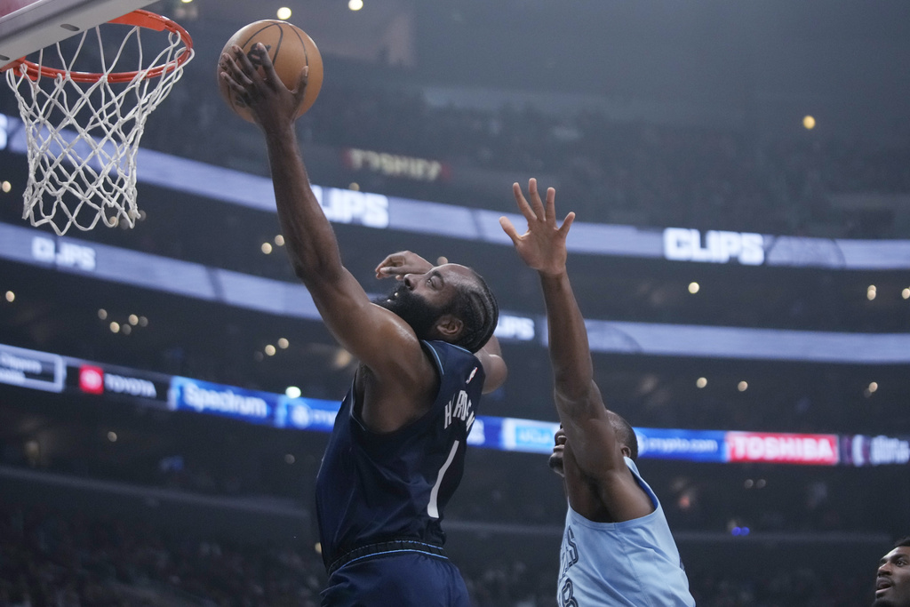 Los Angeles Clippers guard James Harden scores against Memphis Grizzlies center Bismack Biyombo during the second half of an NBA basketball game in Los Angeles on Friday, Dec. 29, 2023.
