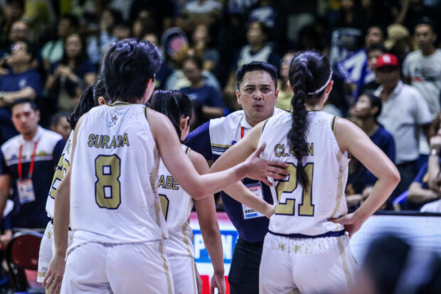 Coach Aris Dimaunahan and the NU Lady Bulldogs in the UAAP Season 86 women's basketball finals.