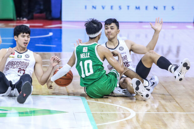La Salle's Evan Nelle tangled up with UP's CJ Cansino and Harold Alarcon in the UAAP Finals Game 3.