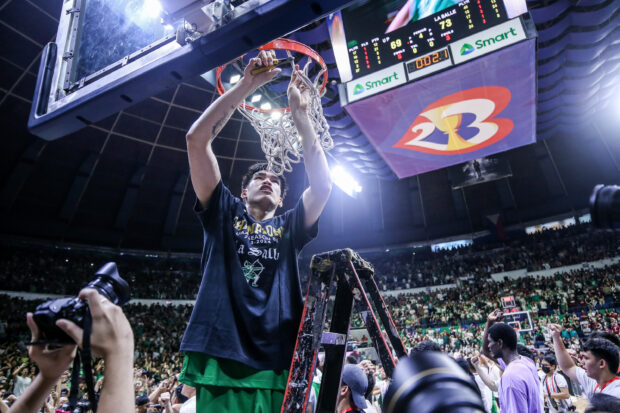 Kevin Quiambao cuts the net after leading La Salle to the UAAP championship in men's basketball.