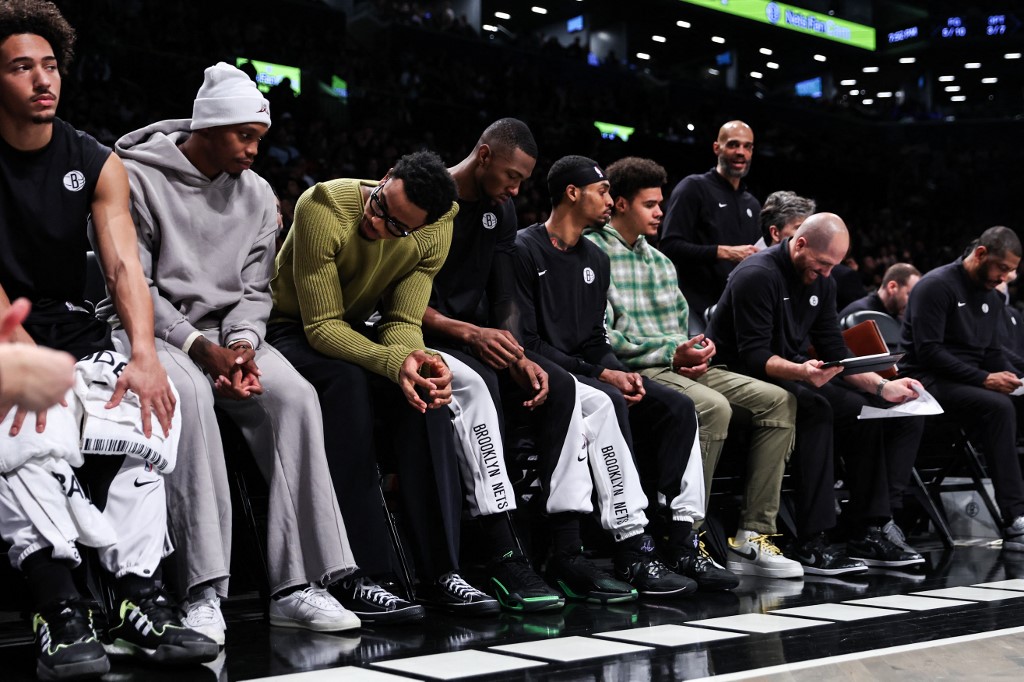  Brooklyn Nets players watch from the bench during the first quarter against the Milwaukee Bucks at Barclays Center on December 27, 2023 in New York City