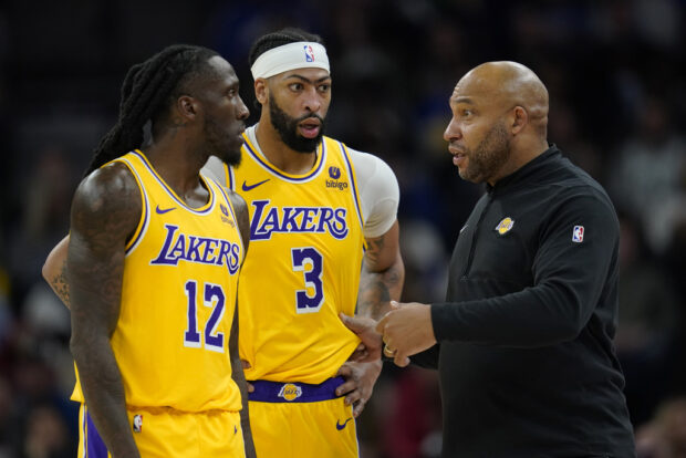 Los Angeles Lakers head coach Darvin Ham talks with forwards Taurean Prince (12) and Anthony Davis (3) during the first half of an NBA basketball game against the Minnesota Timberwolves, Thursday, Dec. 21, 2023, in Minneapolis.