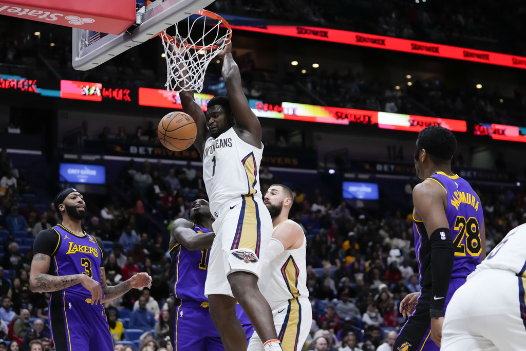 Williamson (1) slam dunks in the first half of an NBA basketball game against the Los Angeles Lakers in New Orleans, Sunday, Dec. 31, 2023. The New Orleans Pelicans won 129-109.
