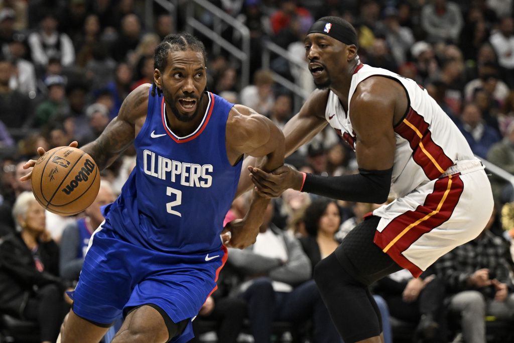 Los Angeles Clippers forward Kawhi Leonard (2) drives past Miami Heat center Bam Adebayo during the second half of an NBA basketball game, Monday, Jan. 1, 2024 in Los Angeles. 