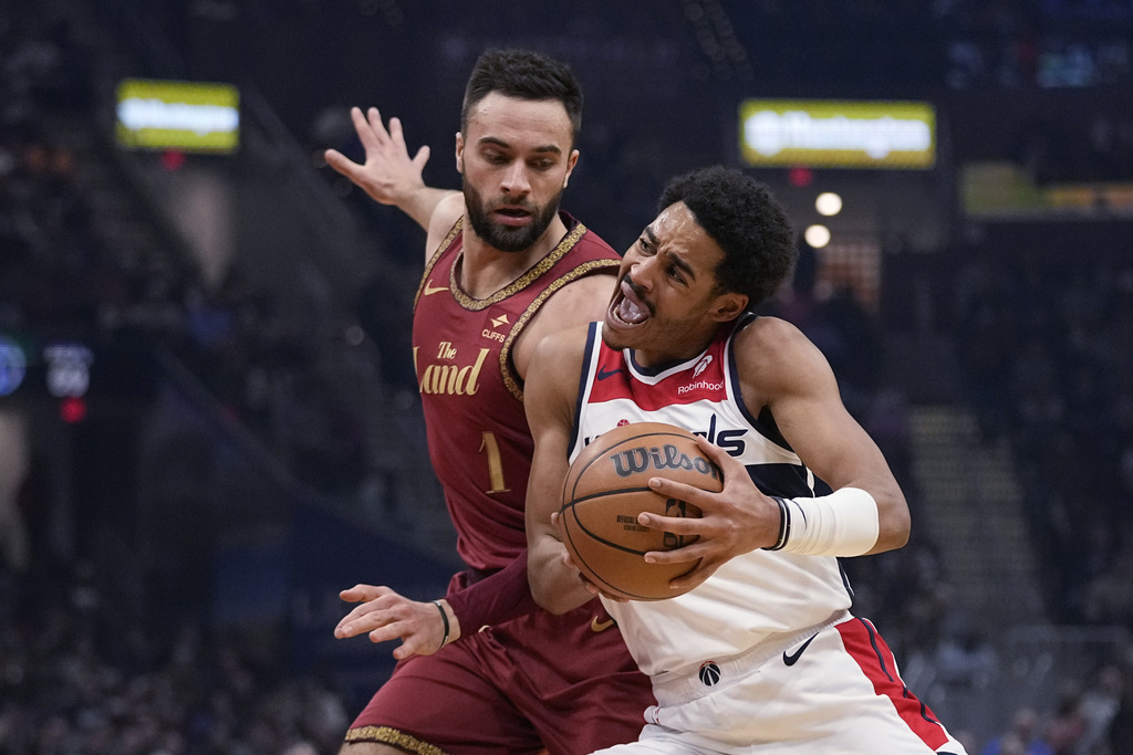 Washington Wizards guard Jordan Poole, right, drives past Cleveland Cavaliers guard Max Strus, left, in the first half of an NBA basketball game Wednesday, Jan. 3, 2024 in Cleveland. 