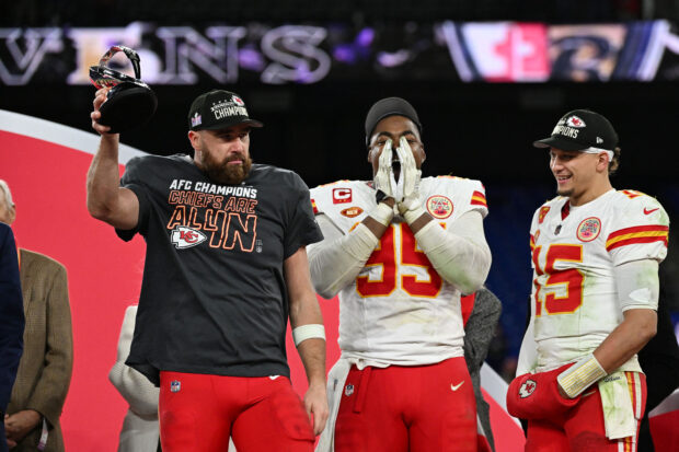 Kansas City Chiefs tight end Travis Kelce (87) holds the Lamar Hunt trophy after winning the AFC Championship football game