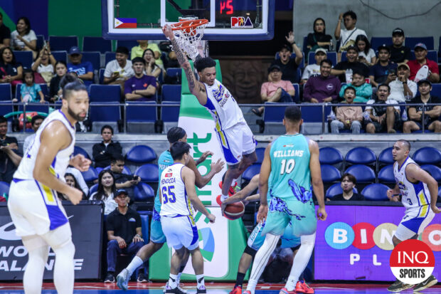 Magnolia import Tyler Bey hangs on to the rim against Phoenix in the PBA Commissioner's Cup semifinals.