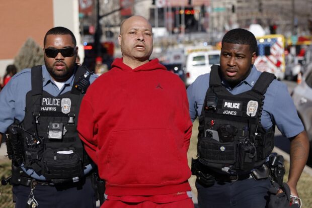 man is detained by law enforcement following a shooting at Union Station during the Kansas City Chiefs Super Bowl LVIII victory parade 