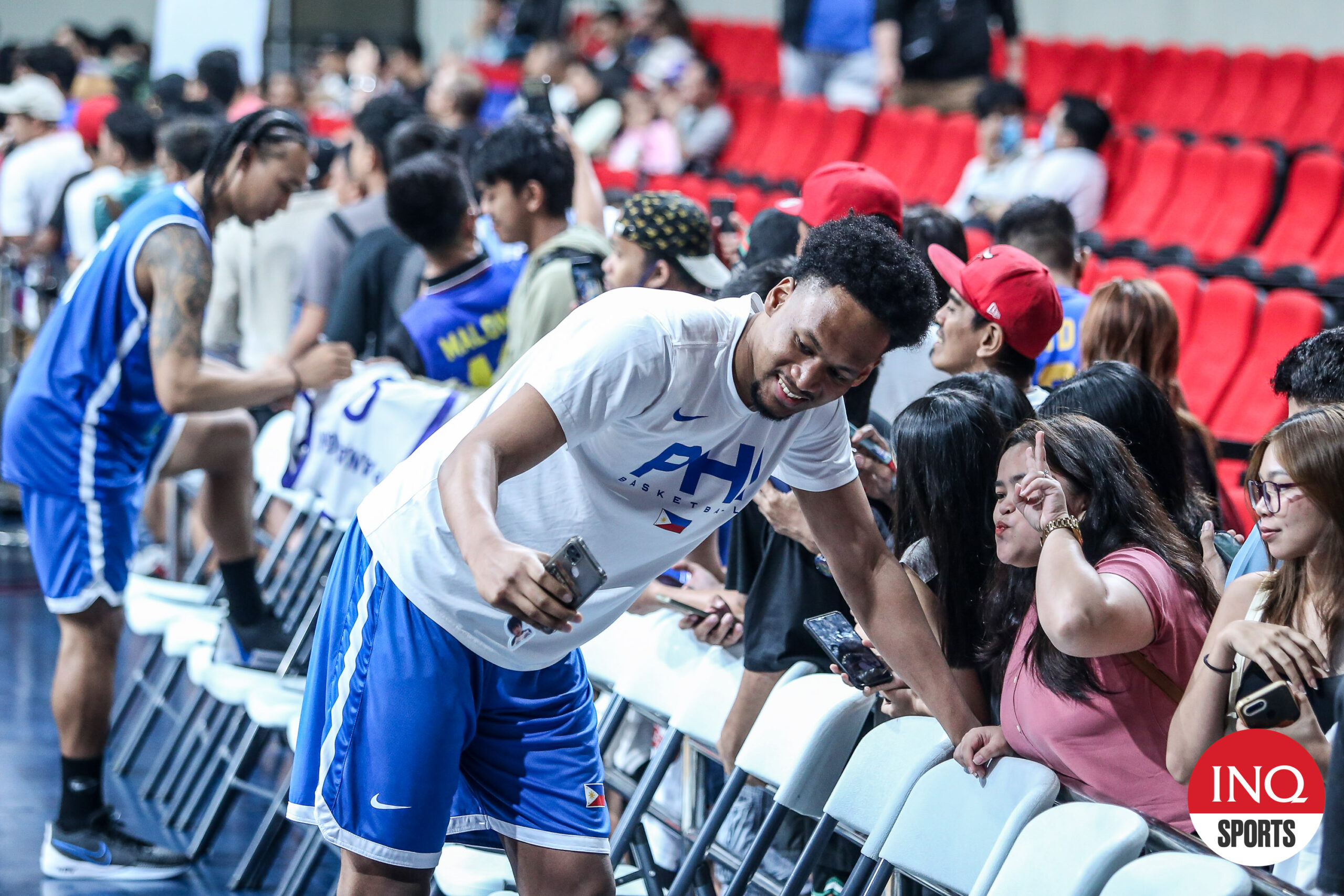 Gilas Pilipinas AJ Edu taking photos with fans after the national team practice. 