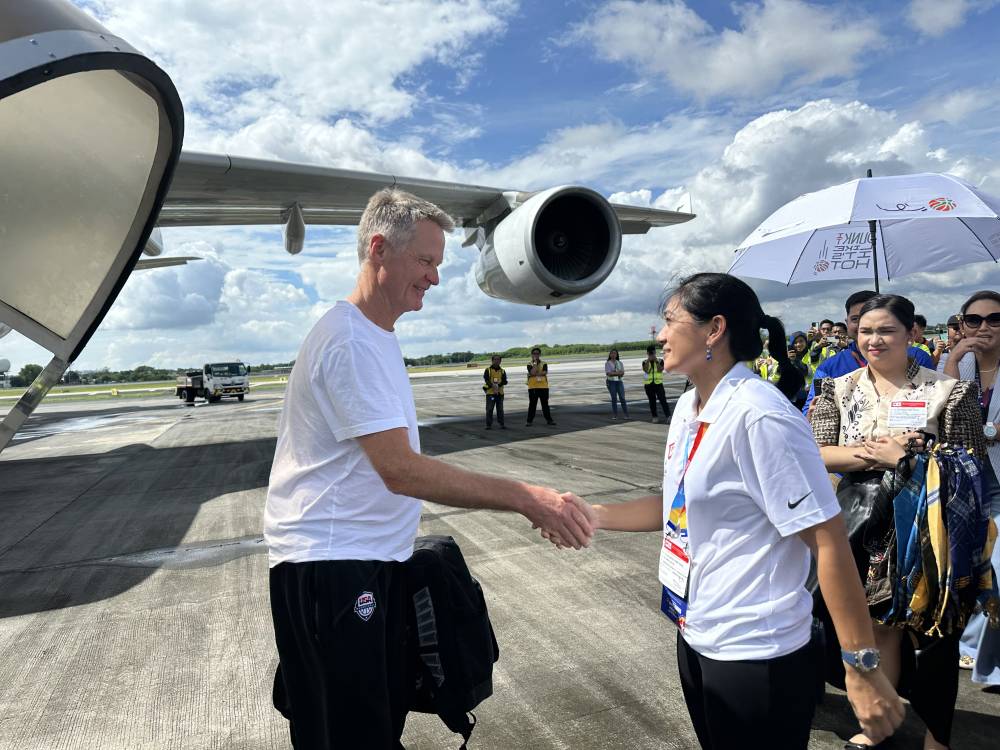 Erika Dy (right) welcomes Team USA coach Steve Kerr during the Fiba World Cup. —PHOTO COURTESY OF ERIKA DY