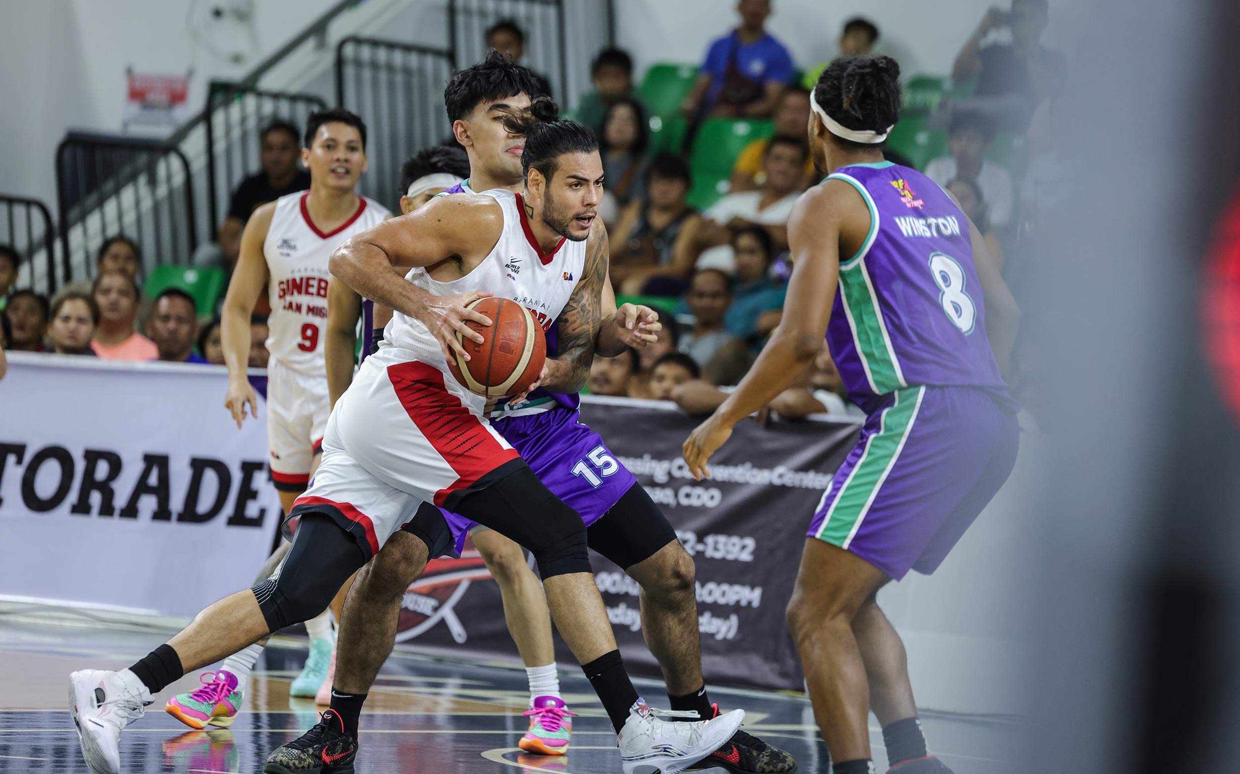 Ginebra Gin Kings' Christian Standhardinger driving against Converge defenders in a PBA Philippine Cup game.