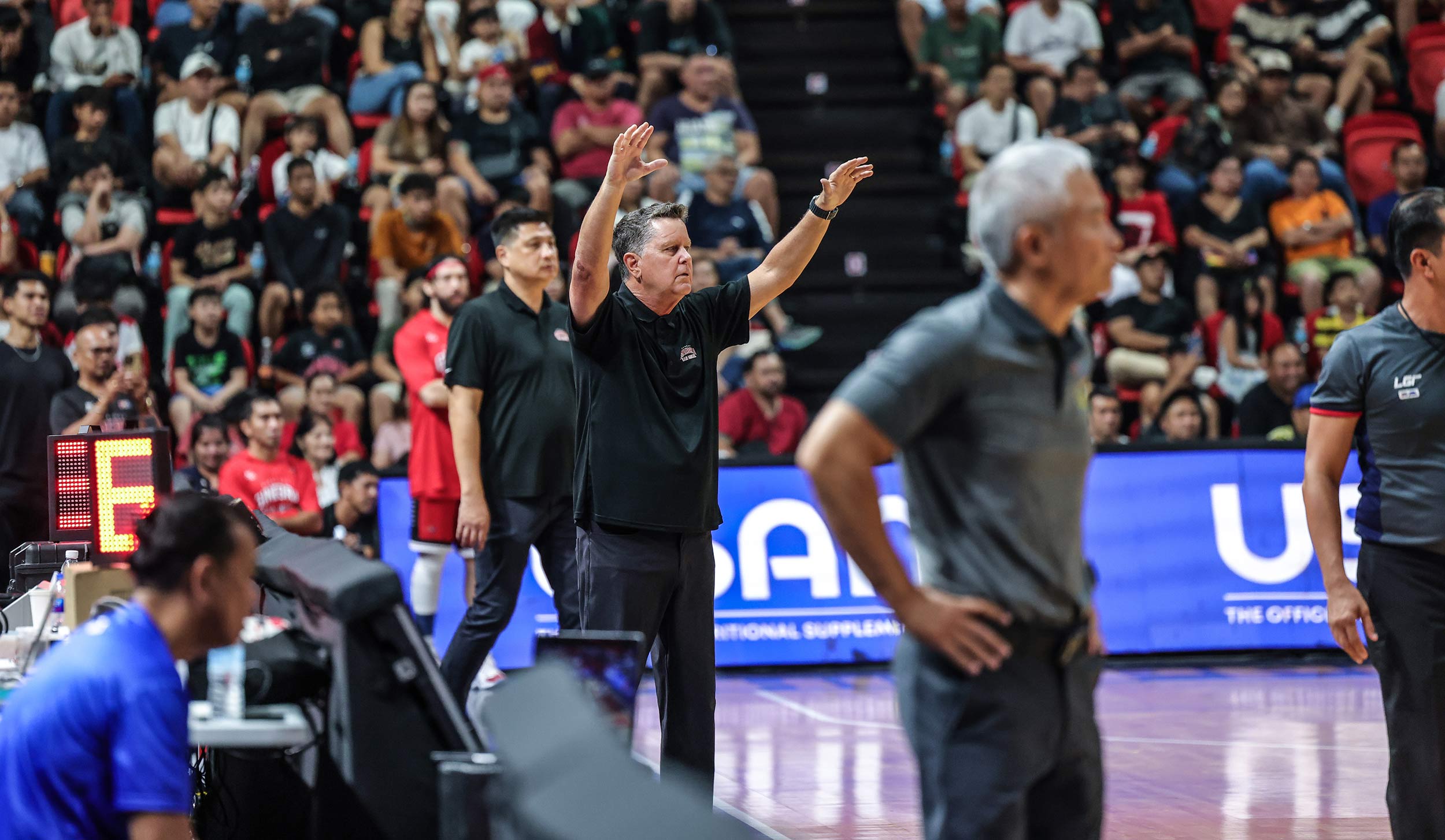 Ginebra coach Tim Cone and TNT coach Chot Reyes (foreground) during a PBA Philippine CUp game.