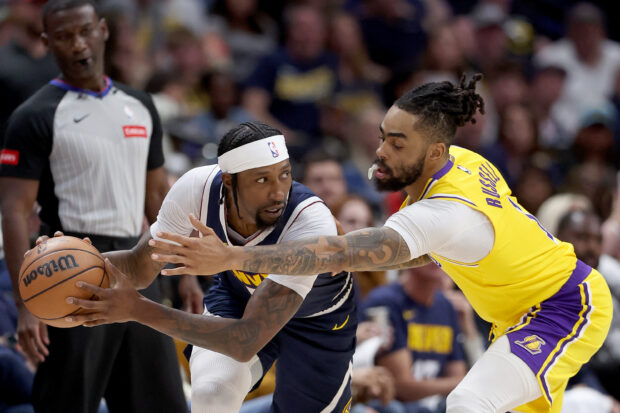 Kentavious Caldwell-Pope #5 of the Denver Nuggets is guarded by D'Angelo Russell #1 of the Los Angeles Lakers in the first quarter during game five of the Western Conference First Round Playoffs at Ball Arena on April 29, 2024 in Denver, Colorado. 