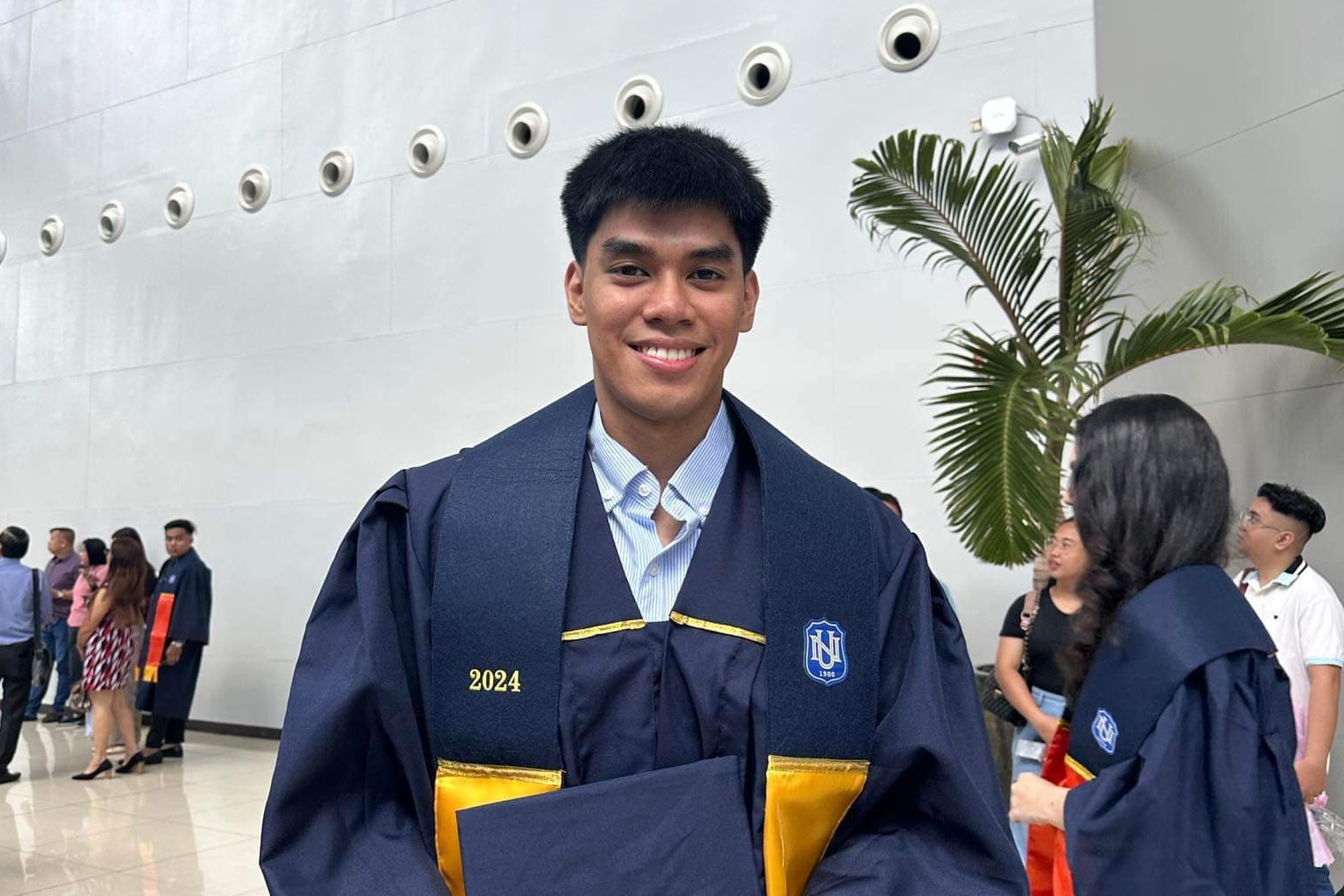 NU Bulldogs' star Owa Retamar gets his degree from National University ahead of the UAAP Season 86 men's volleyball finals.