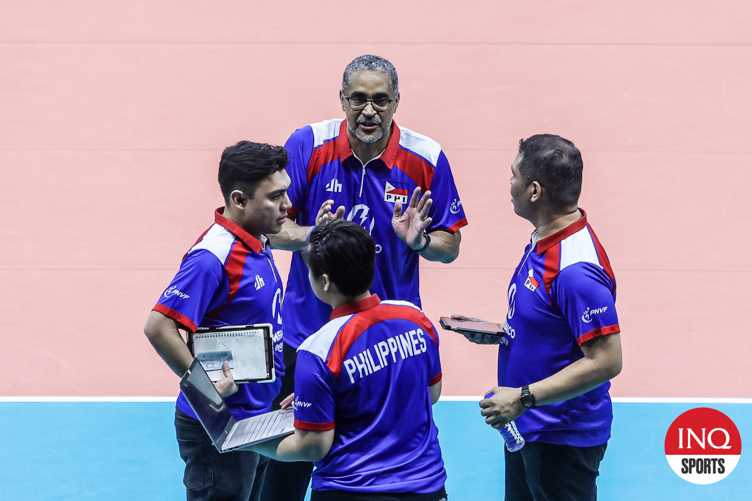 Alas Pilipinas coach Jorge Souza de Brito talks to his coaching staff during an AVC Challenge Cup 2024 game.