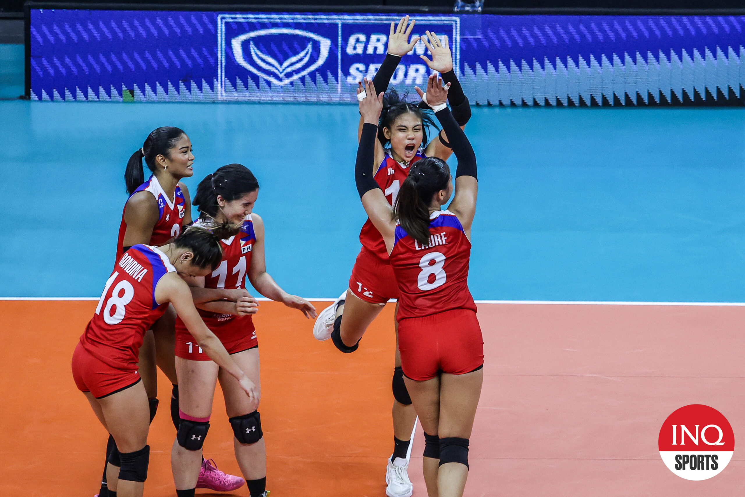 Eya Laure and Angel Canino for a high five during an AVC Challenge Cup game