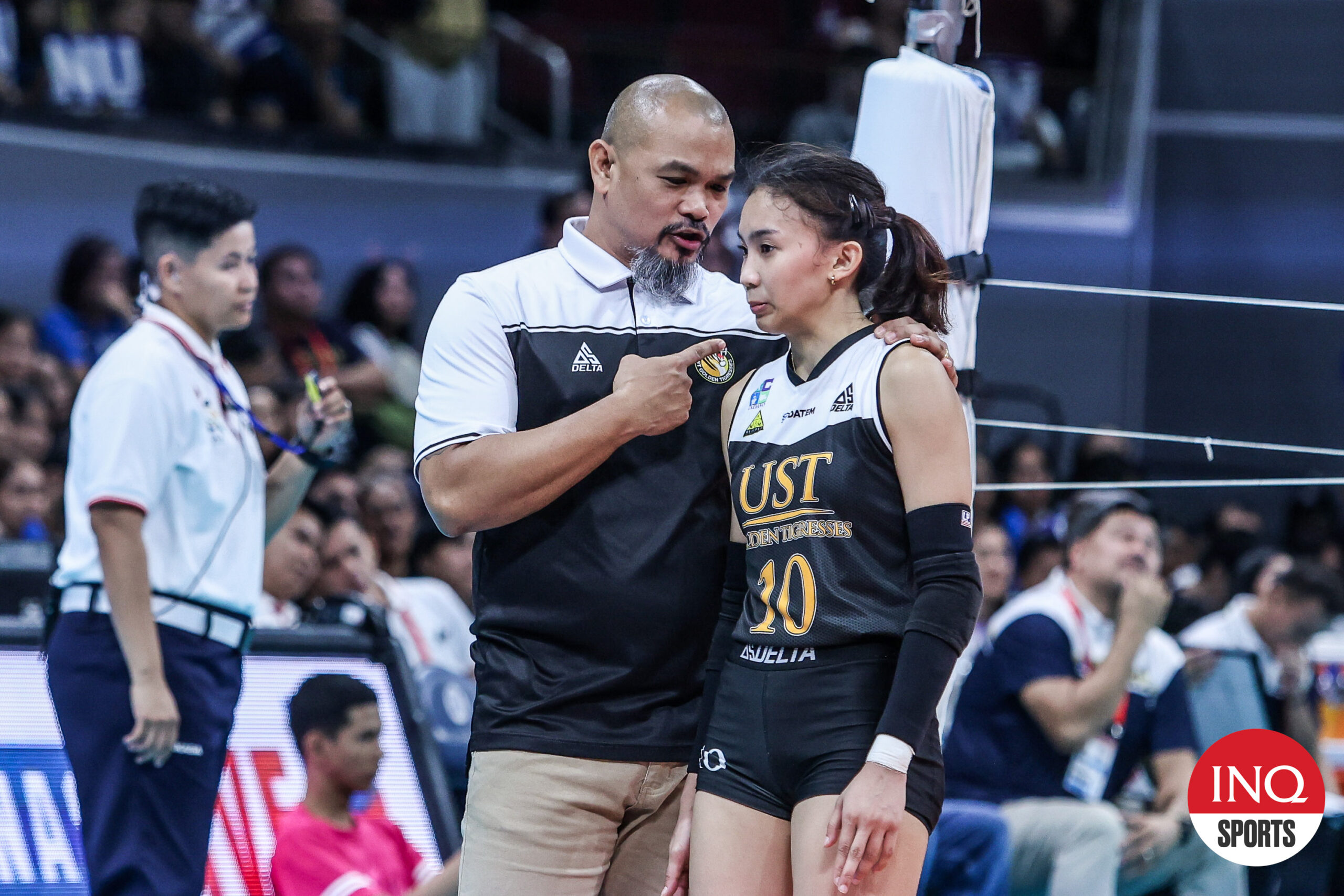 UST Tigresses' Xyza Gula with coach KungFu Reyes during the UAAP Season 86 women's Finals game against NU Bulldogs