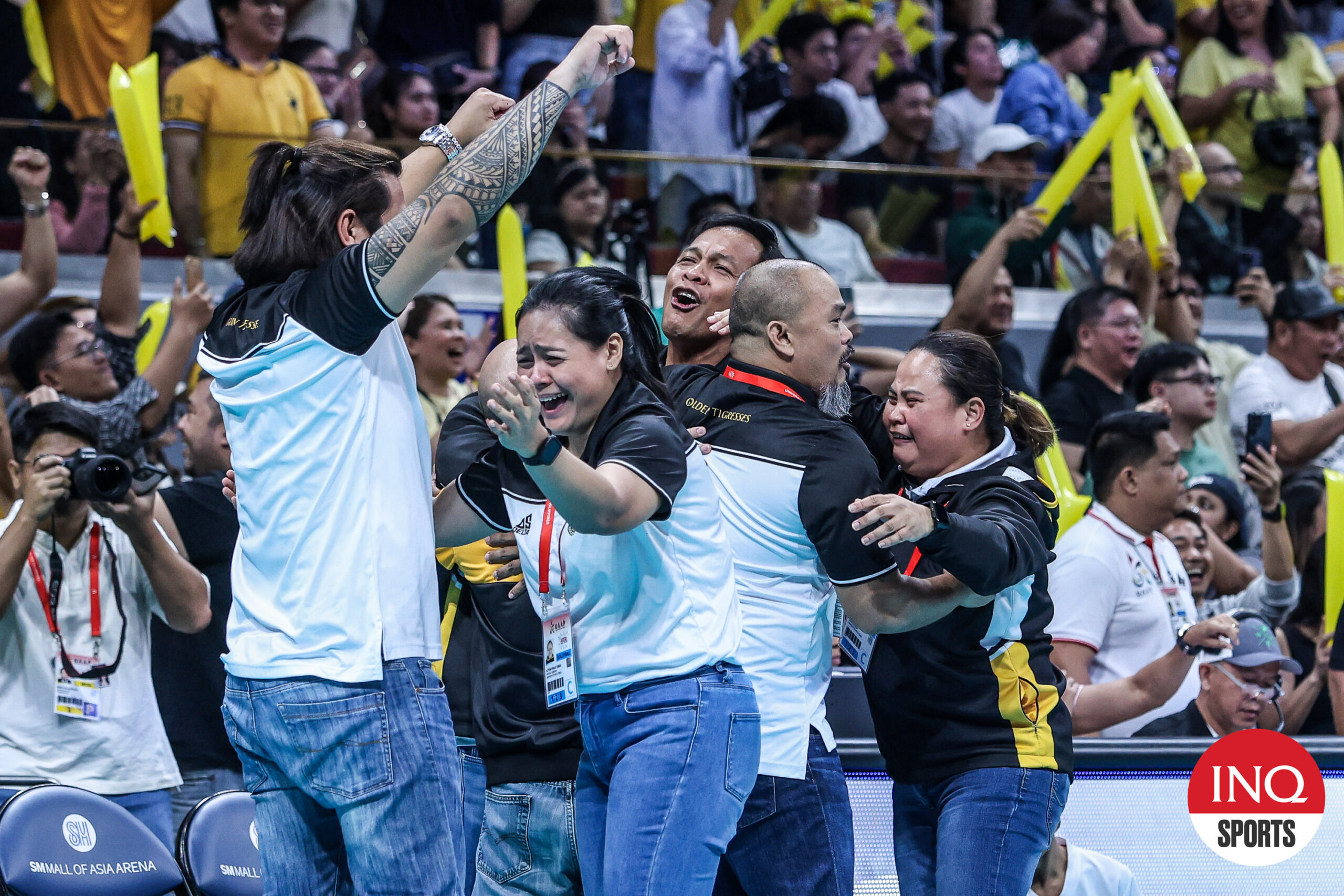 Shaq Delos Santos along with the UST Tigresses coaching staff celebrate after entering the UAAP Season 86 women's volleyball tournament.