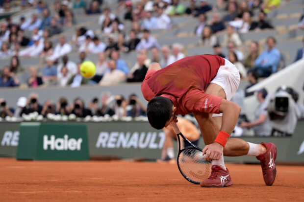 Serbia's Novak Djokovic falls on the court during his men's singles round of sixteen match against Argentina's Francisco Cerundolo on Court Philippe-Chatrier on day nine of the French Open tennis tournament at the Roland Garros Complex in Paris on June 3, 2024. 