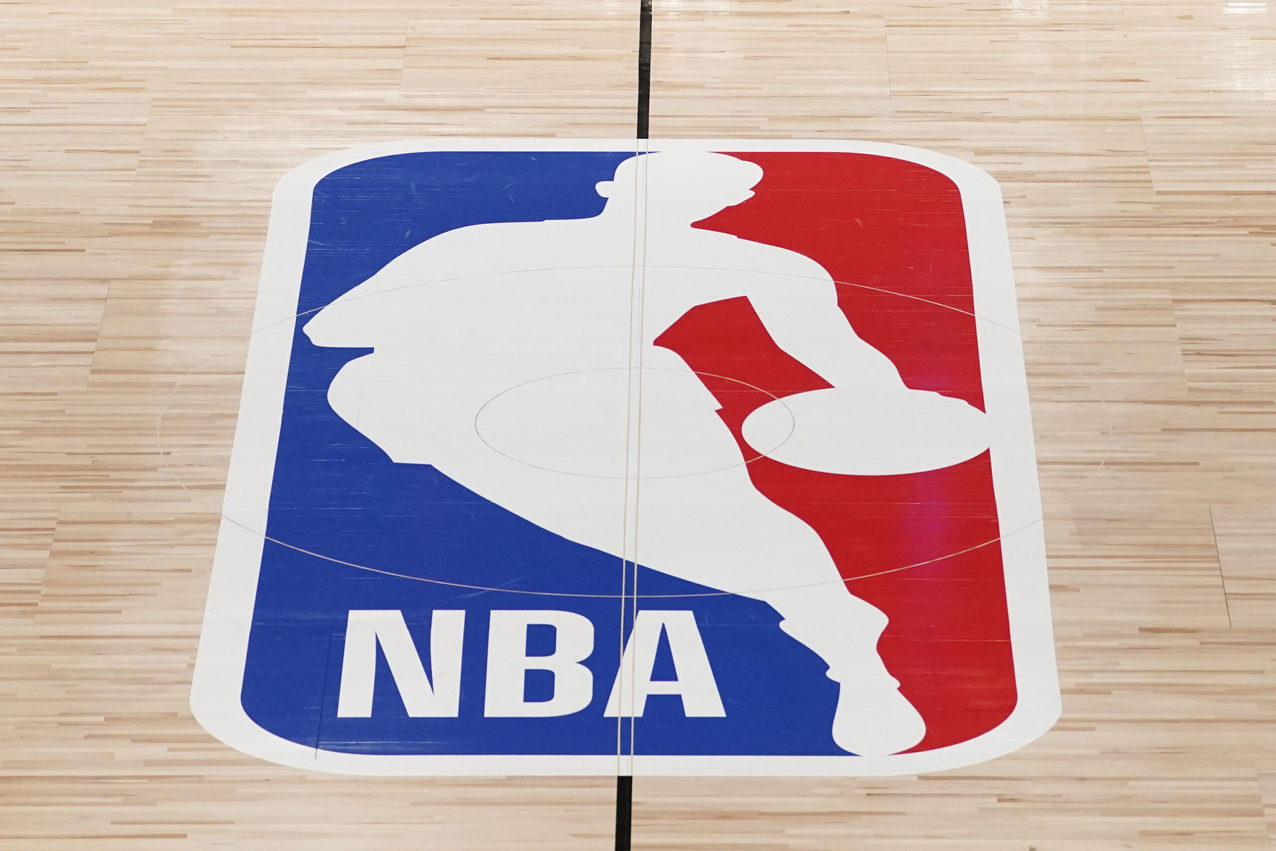 FILE - The NBA logo in shown on a basketball court in Lake Buena Vista, Fla., Friday, Aug. 28, 2020. Jerry West, who was selected to the Basketball Hall of Fame three times in a legendary career as a player and executive and whose silhouette is considered to be the basis of the NBA logo, died Wednesday morning, June 12, 2024, the Los Angeles Clippers announced.