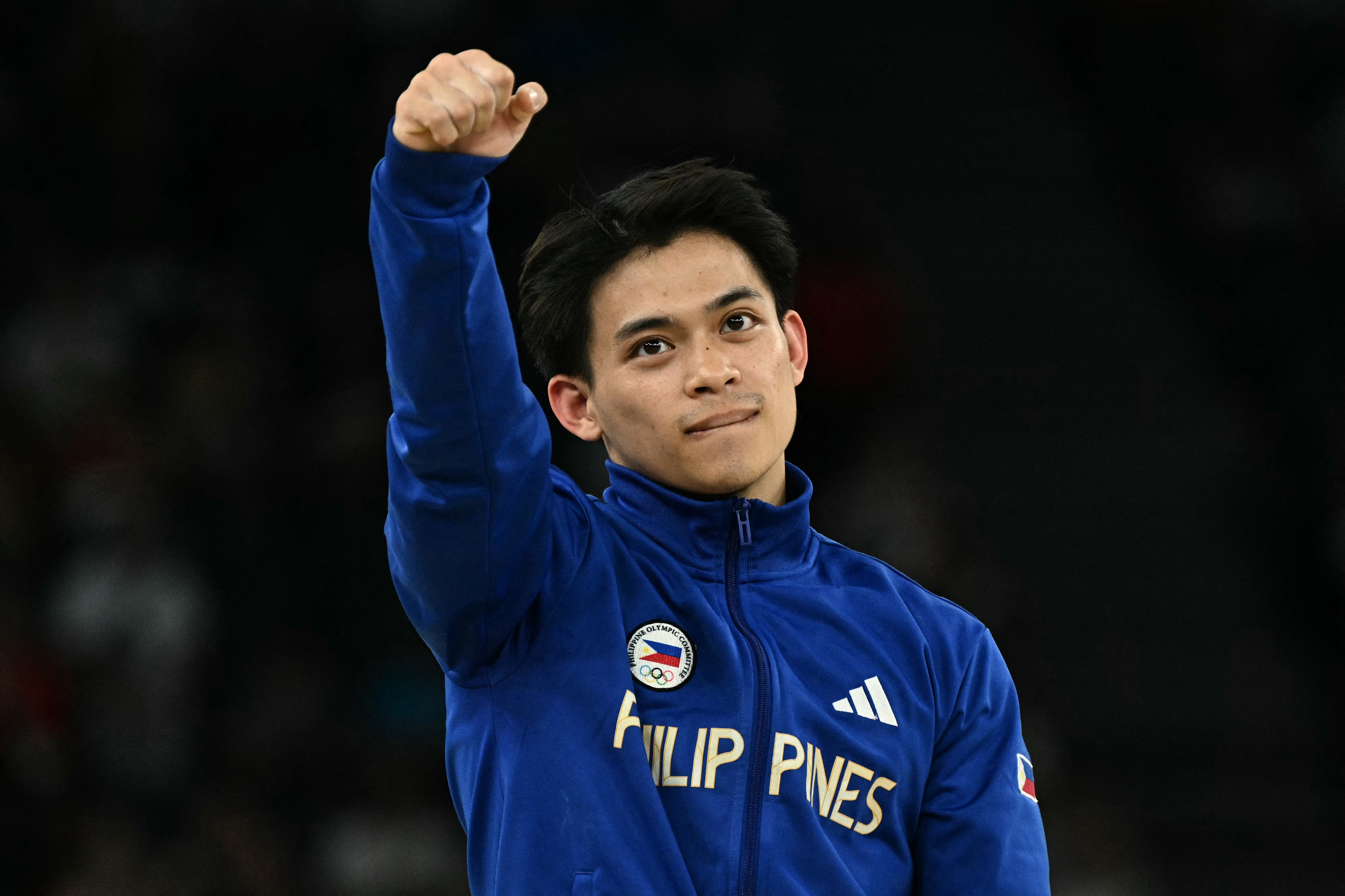 Philippines' Carlos celebrates winning the gold medal during the podium ceremony for the artistic gymnastics men's vault event of the Paris 2024 Olympic Games at the Bercy Arena in Paris, on August 4, 2024. (Photo by Lionel BONAVENTURE / AFP)