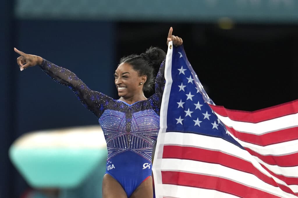 Simone Biles, of the United States, celebrates after winning the gold medal during the women's artistic gymnastics all-around finals in Bercy Arena at the 2024 Summer Olympics, Thursday, Aug. 1, 2024, in Paris, France.