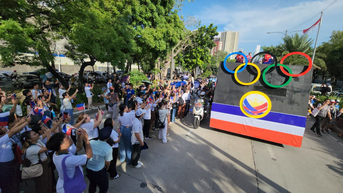 An ecstatic heroes' welcome for the country's victorious' Olympians. Parade is now on Roxas Blvd with onlookers waving small Philippine flags and shouting names of Olympians.