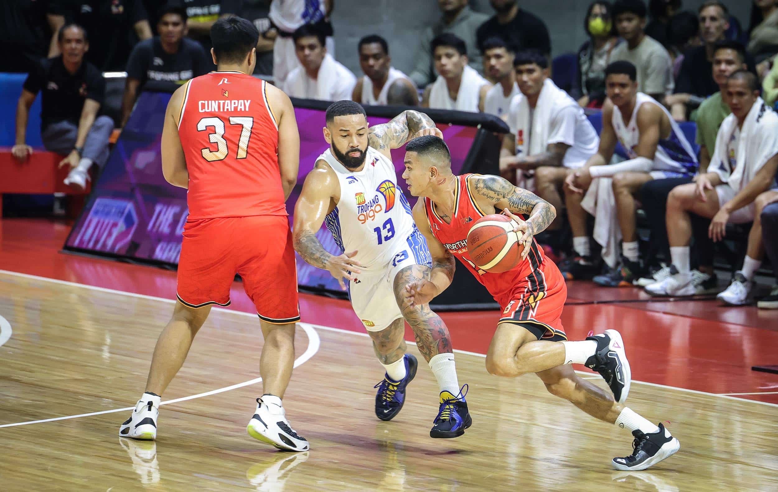 PBA NorthPort Batang Pier guard Jio Jalalon going up against TNT's Brian Heruela