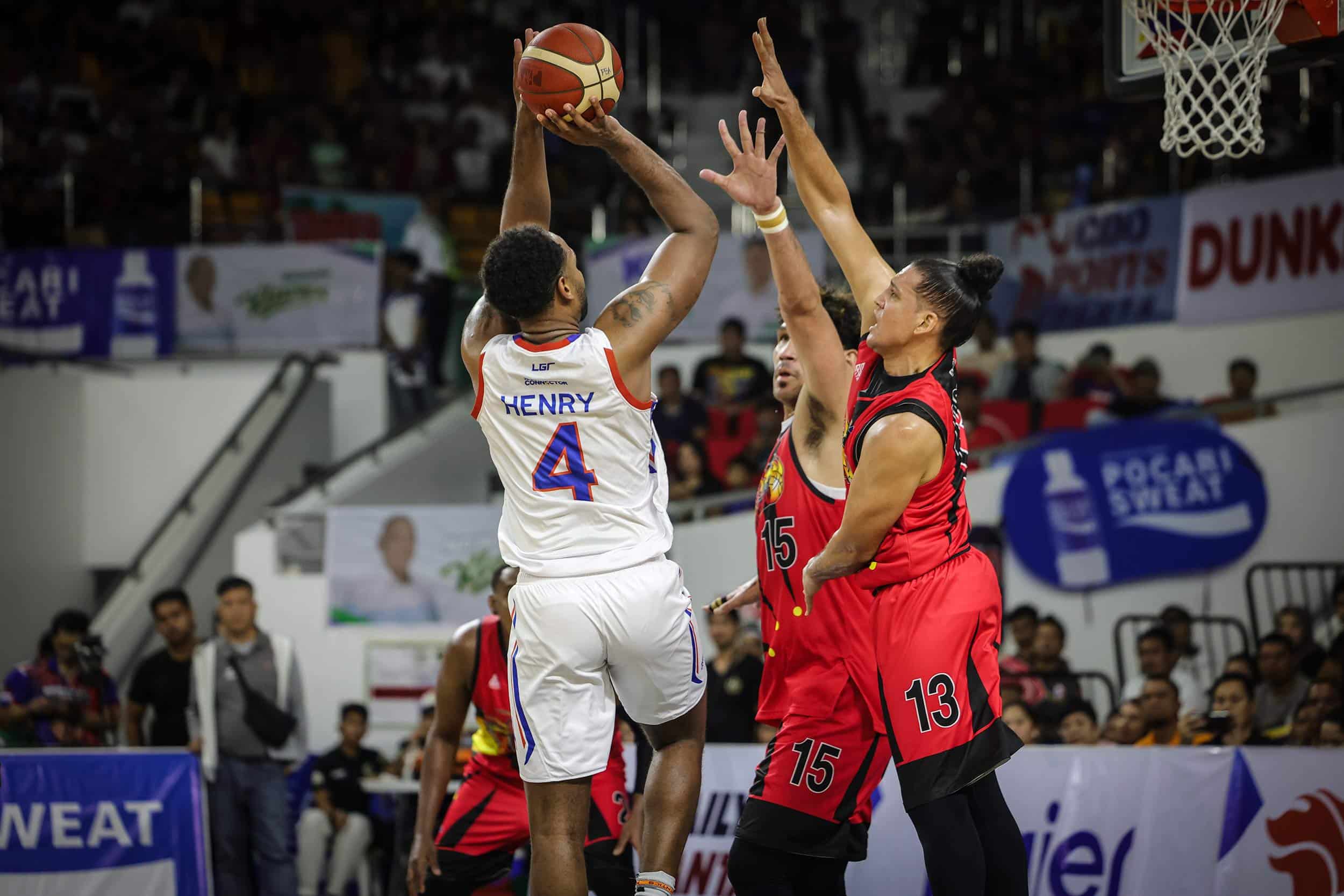 NLEX Road Warriors' Myke Henry against San Miguel Beermen's June Mar Fajardo and Marcio Lassiter.