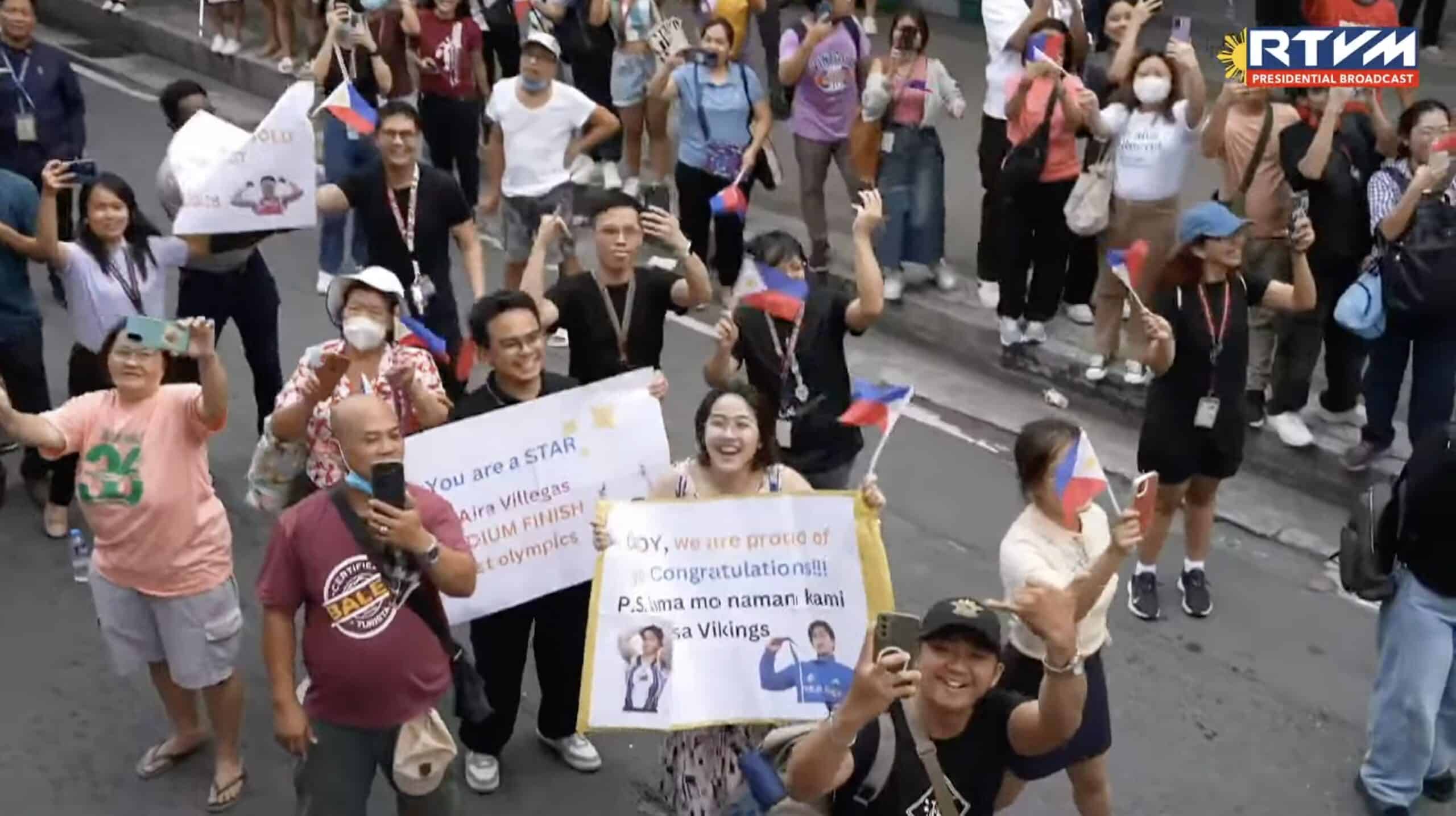 Fans in the crowd during the Heroes Parade of the Filipino Olympians along the streets of Manila and Pasay.