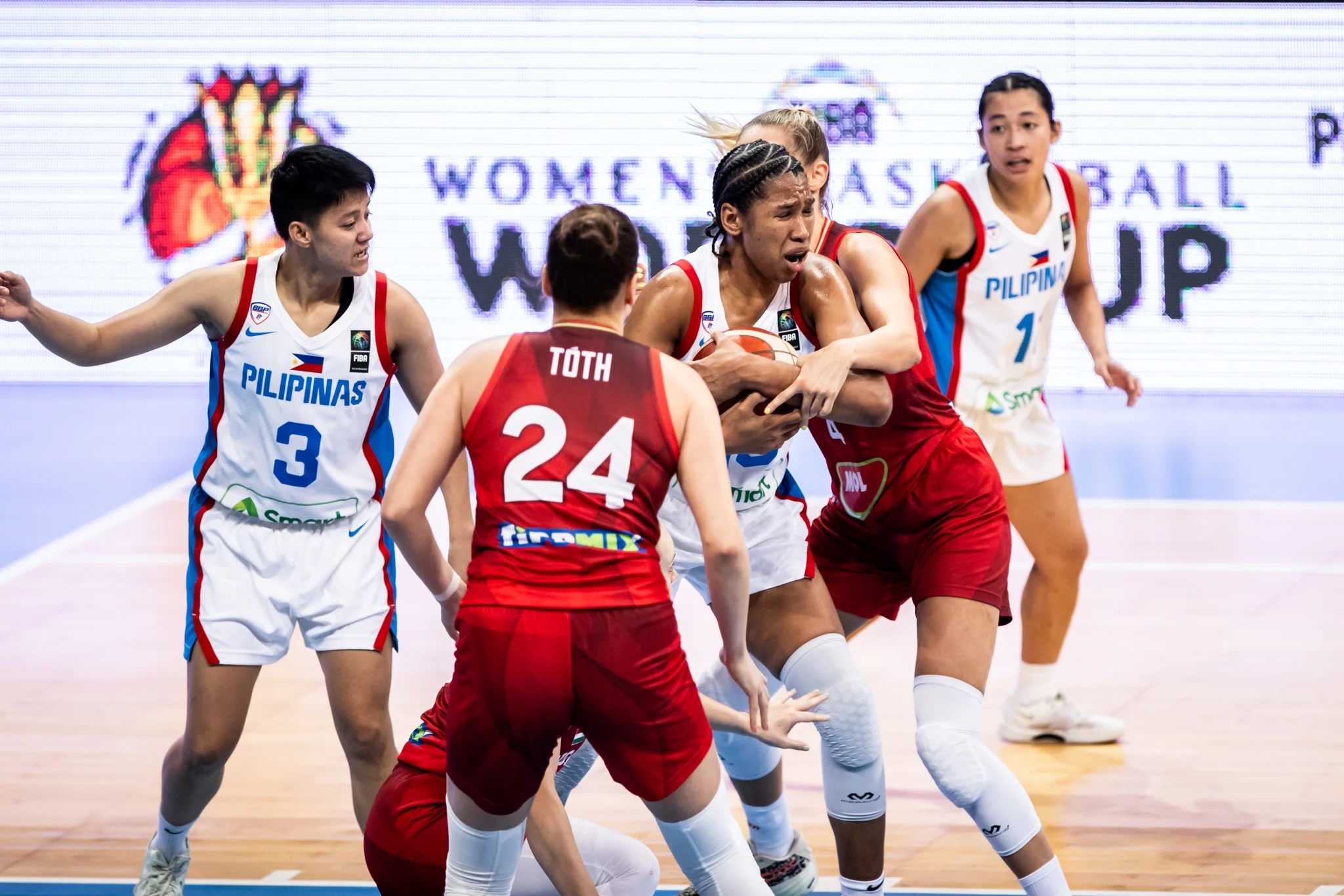 Gilas Pilipinas women star Jack Animam flanked by Hungary defenders during a 2026 Fiba Women’s World Cup Pre-Qualifying tournament game in Rwanda.