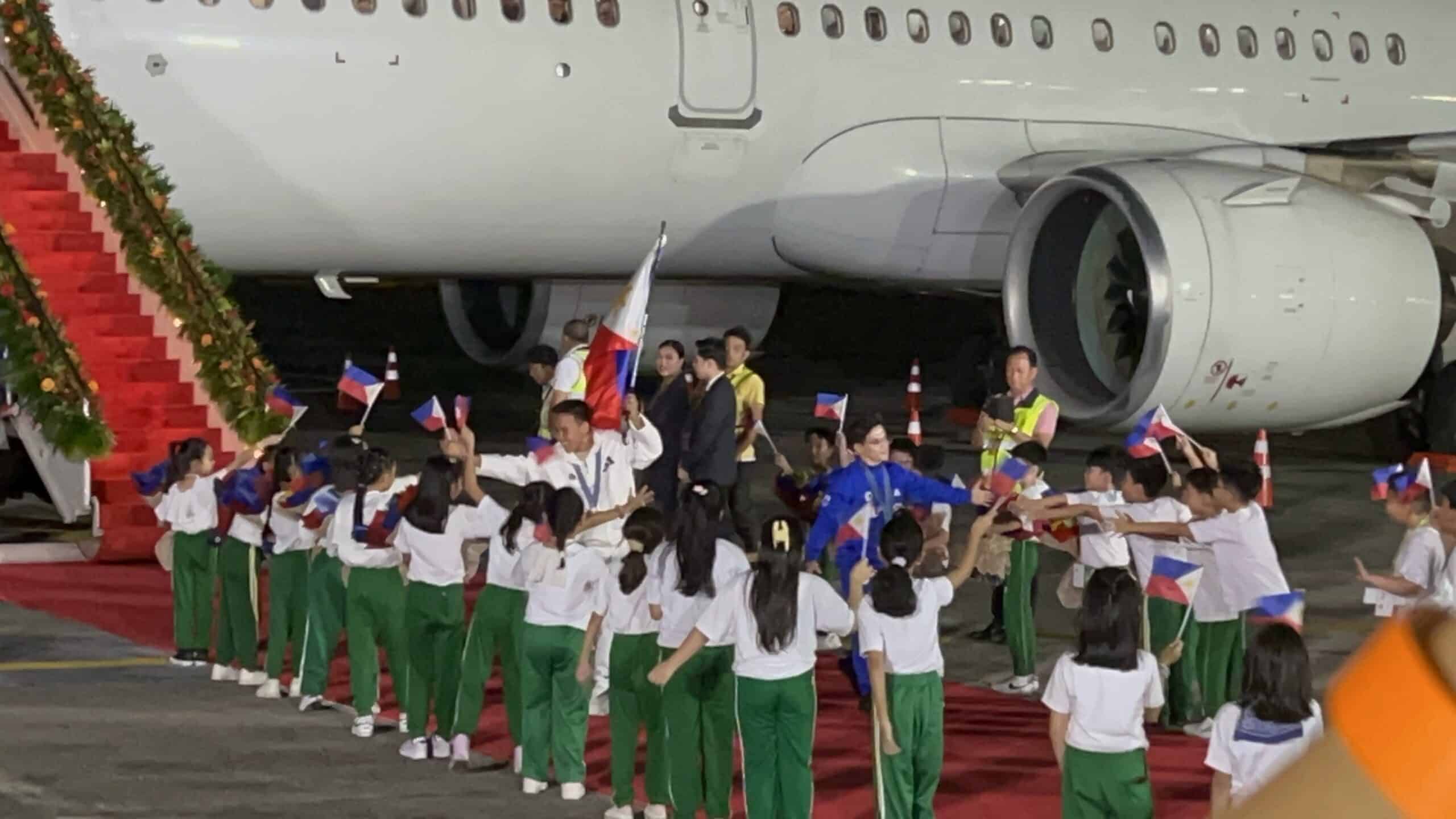 Os medalhistas olímpicos Nesthy Petecio e Carlos Yulo caminham no tapete vermelho ao chegarem a Manila após os Jogos Olímpicos de Verão de Paris. A seleção das Filipinas