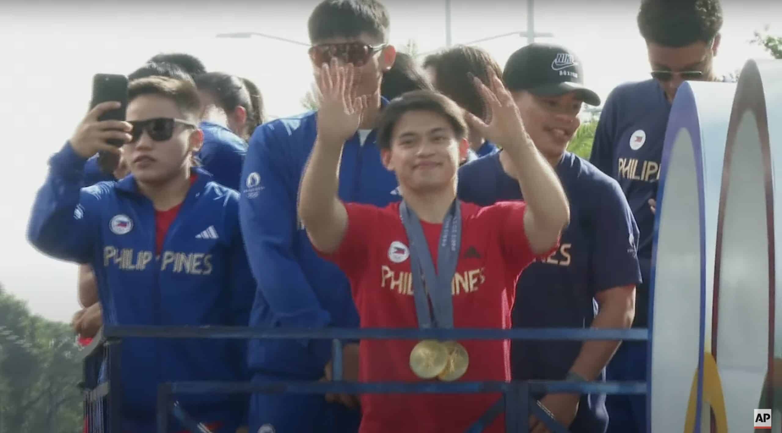 Carlos Yulo wearing his gold medals from the Paris Olympics