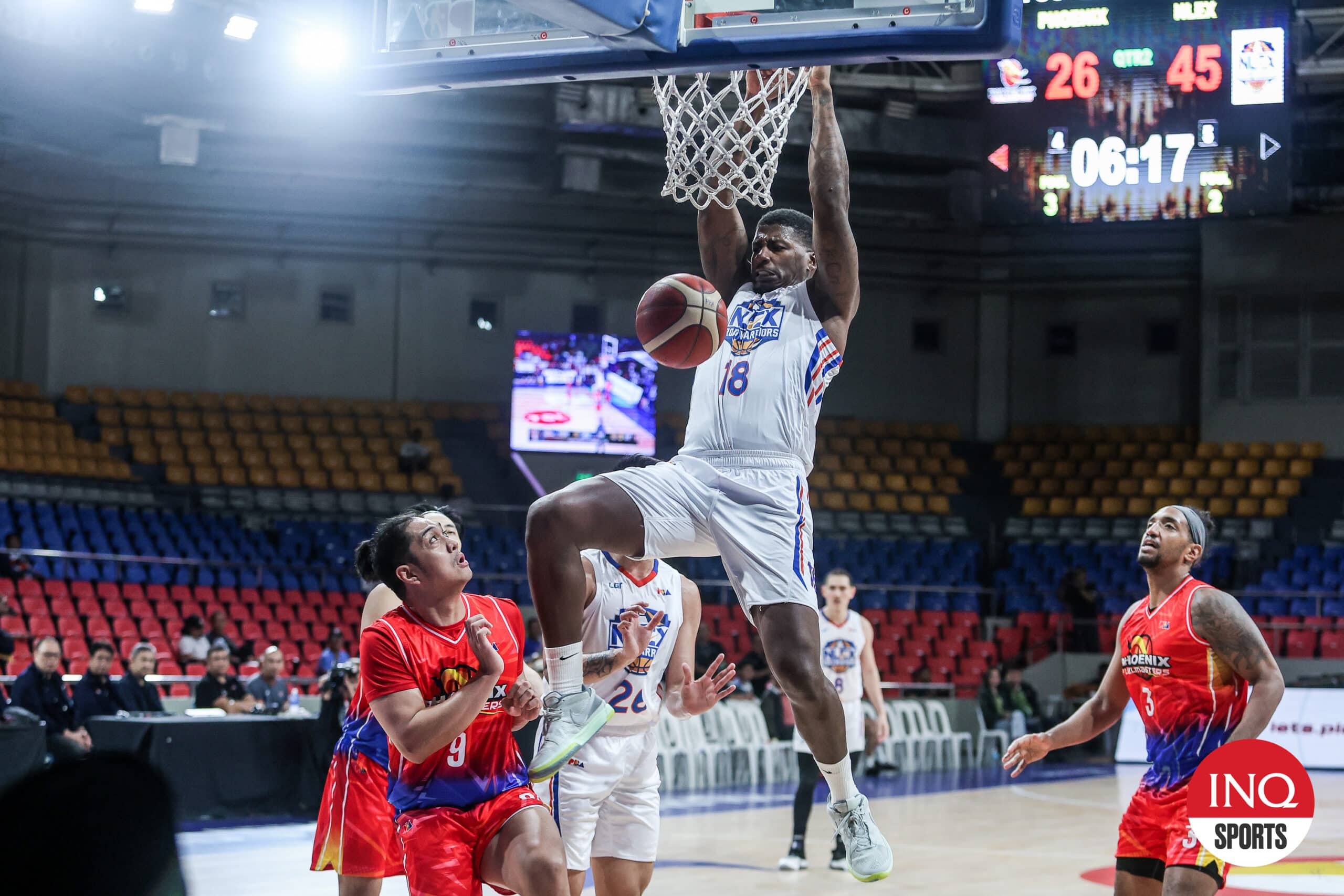 NLEX Road Warriors' import DeQuan Jones throws it down as Phoenix defenders look on during a PBA Governors' Cup game. 