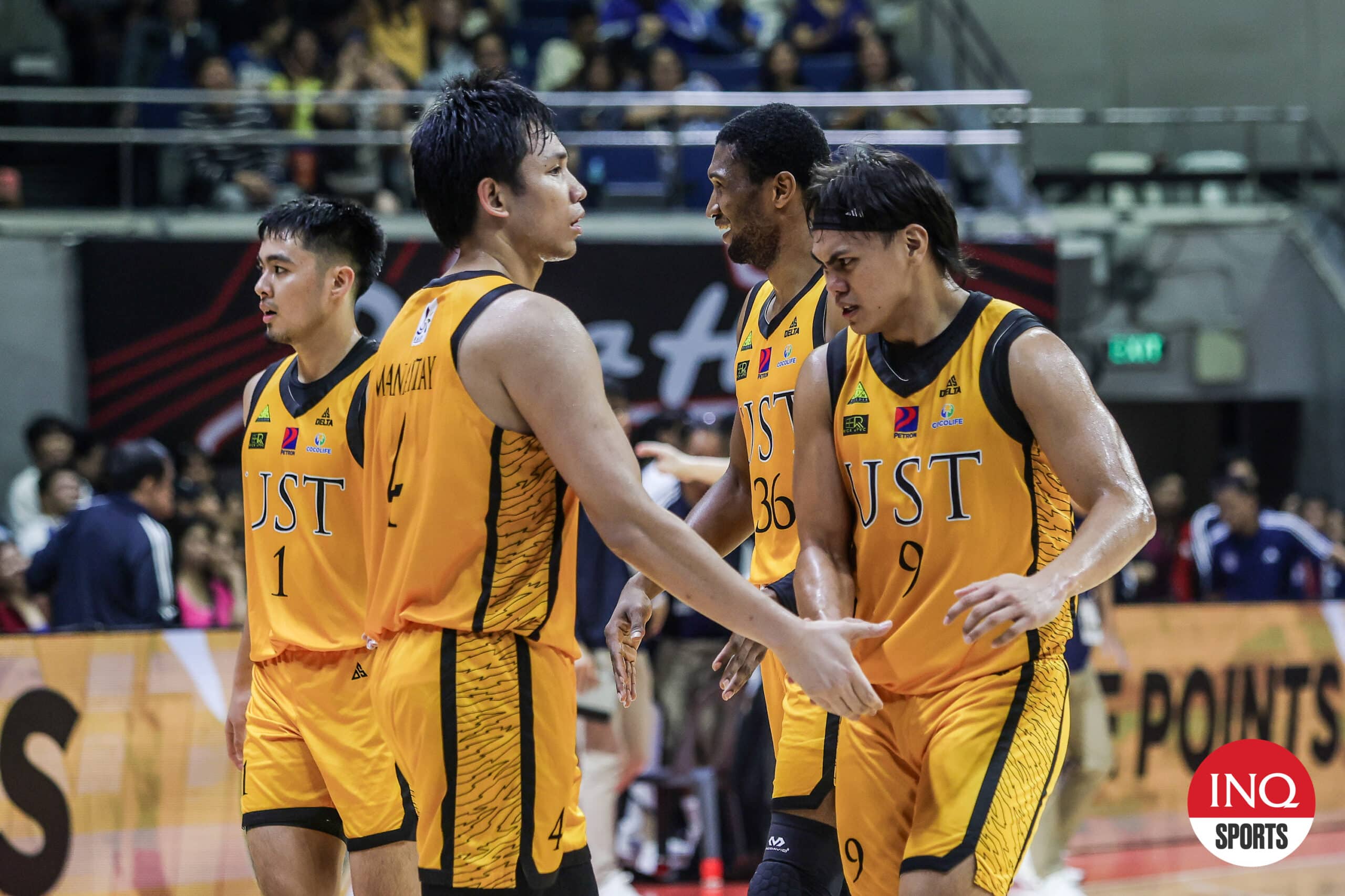 Christian Manaytay and Nic Cabañero headed to the UST Growling Tigers bench during a UAAP Season 87 men's basketball game.