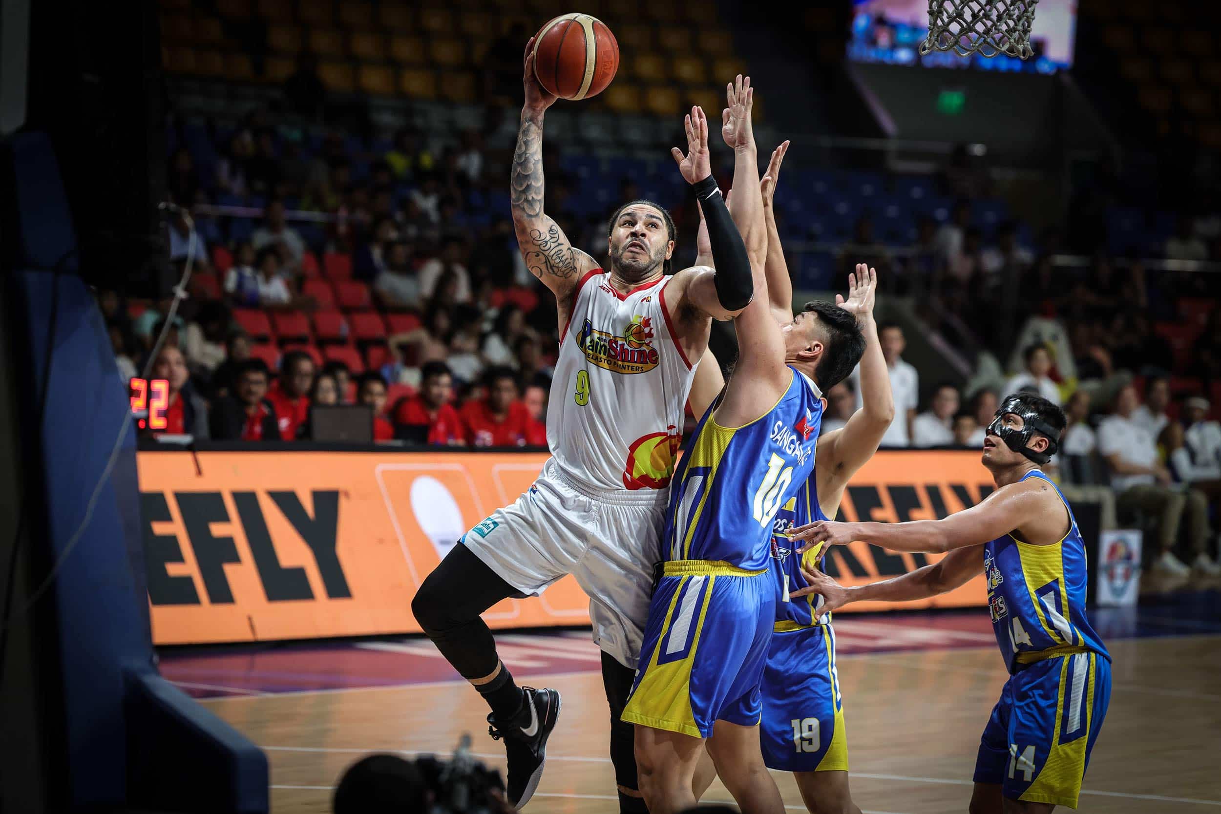 Rain or Shine Elastopainters' Aaron Fuller rises for a shot against Magnolia defenders during a PBA Governors' Cup quarterfinals game.