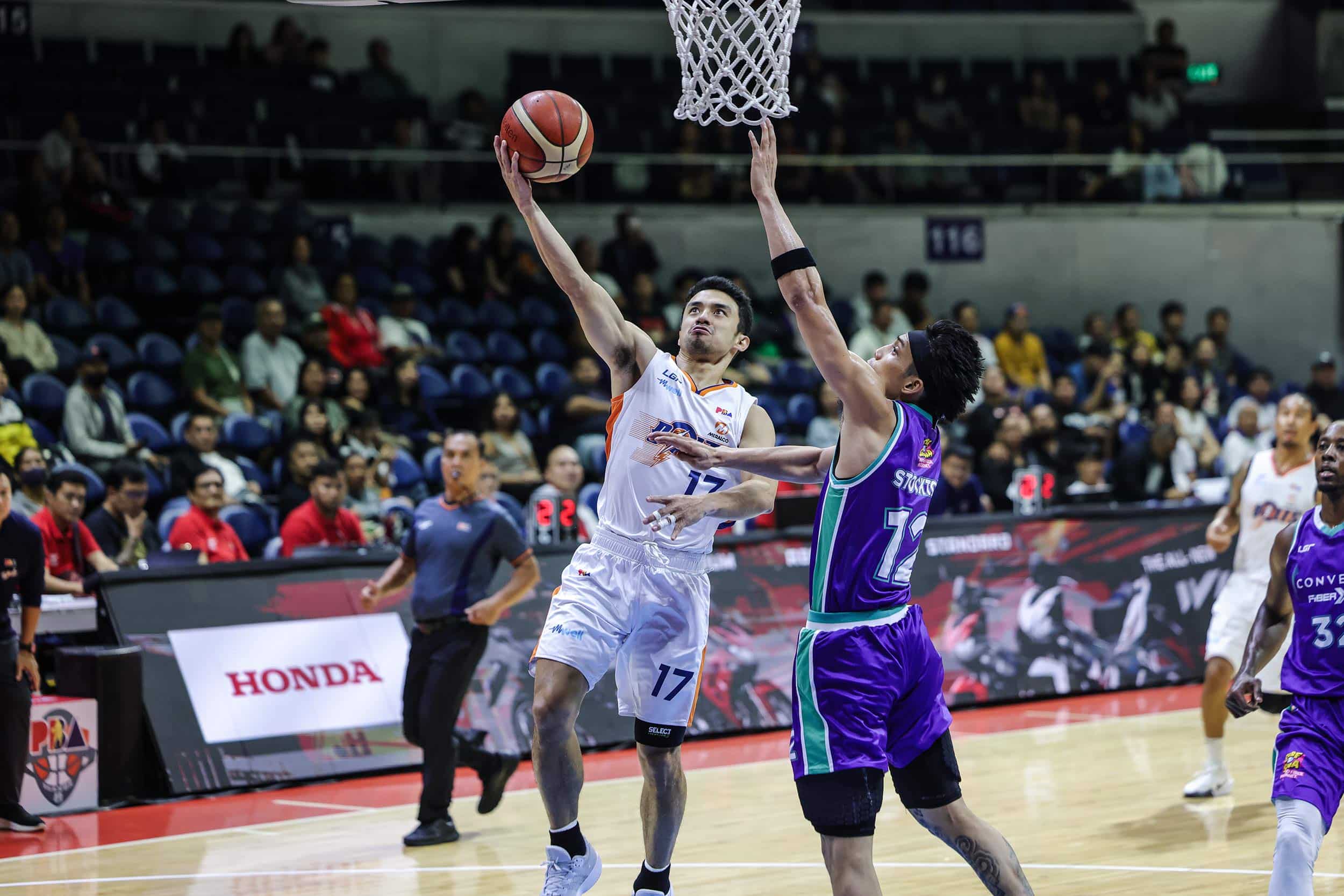 Meralco Bolts' Anjo Caram against a Converge defender during the PBA Governors' Cup.