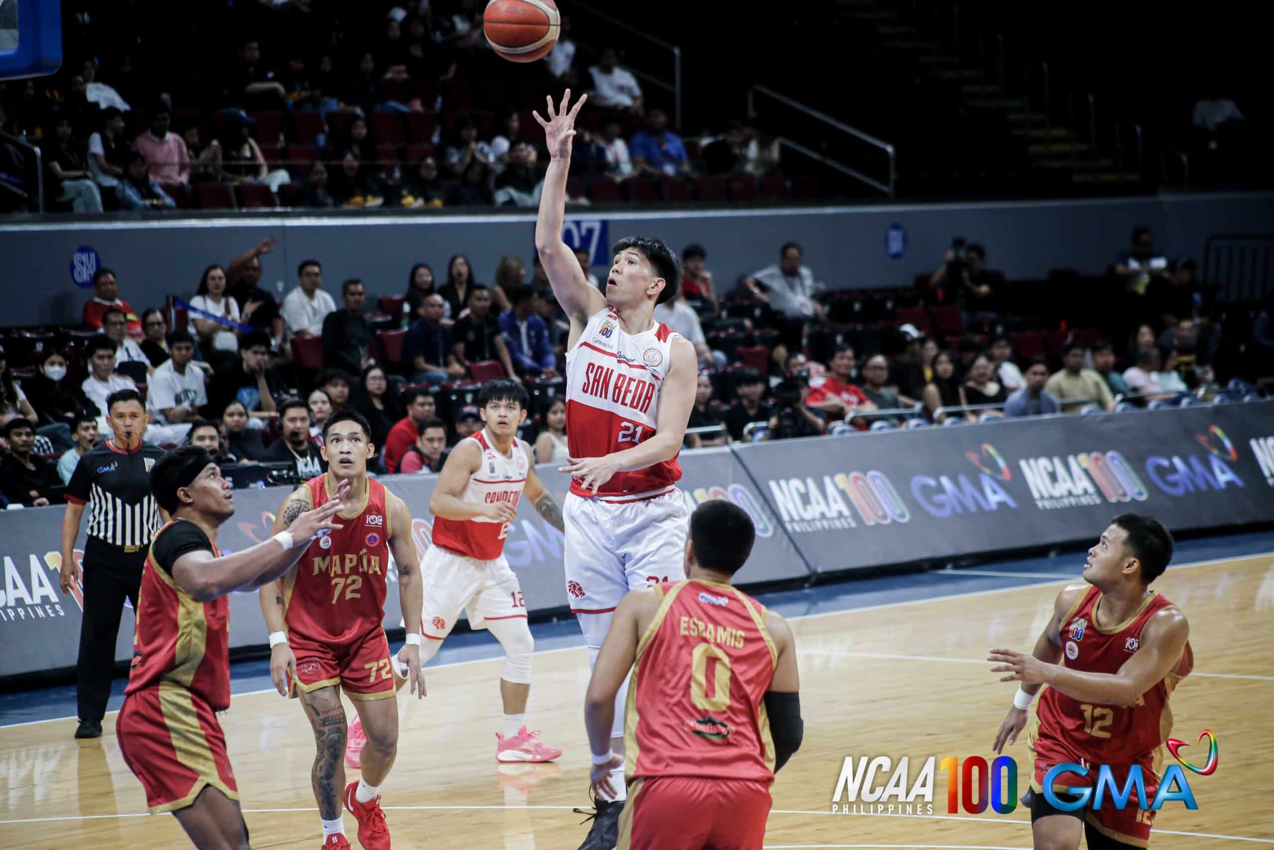 San Beda Red Lions' Yukien Andrada goes up for a teardrop against Mapua defenders during an NCAA Season 100 men's basketball game