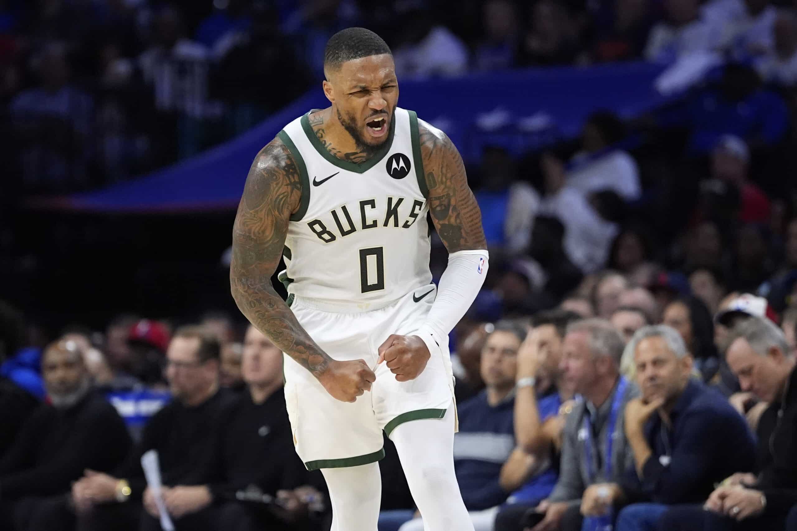 Milwaukee Bucks' Damian Lillard reacts after making a basket during the second half of an NBA basketball game 