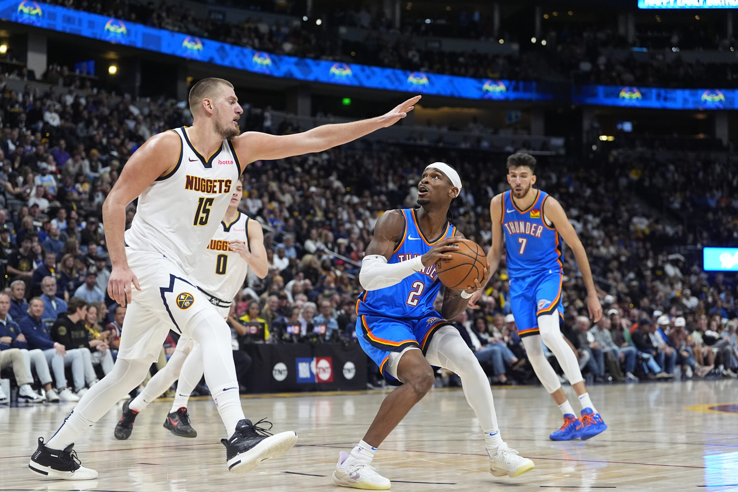 Denver Nuggets center Nikola Jokic, left, blocks Oklahoma City Thunder guard Shai Gilgeous-Alexander NBA scores