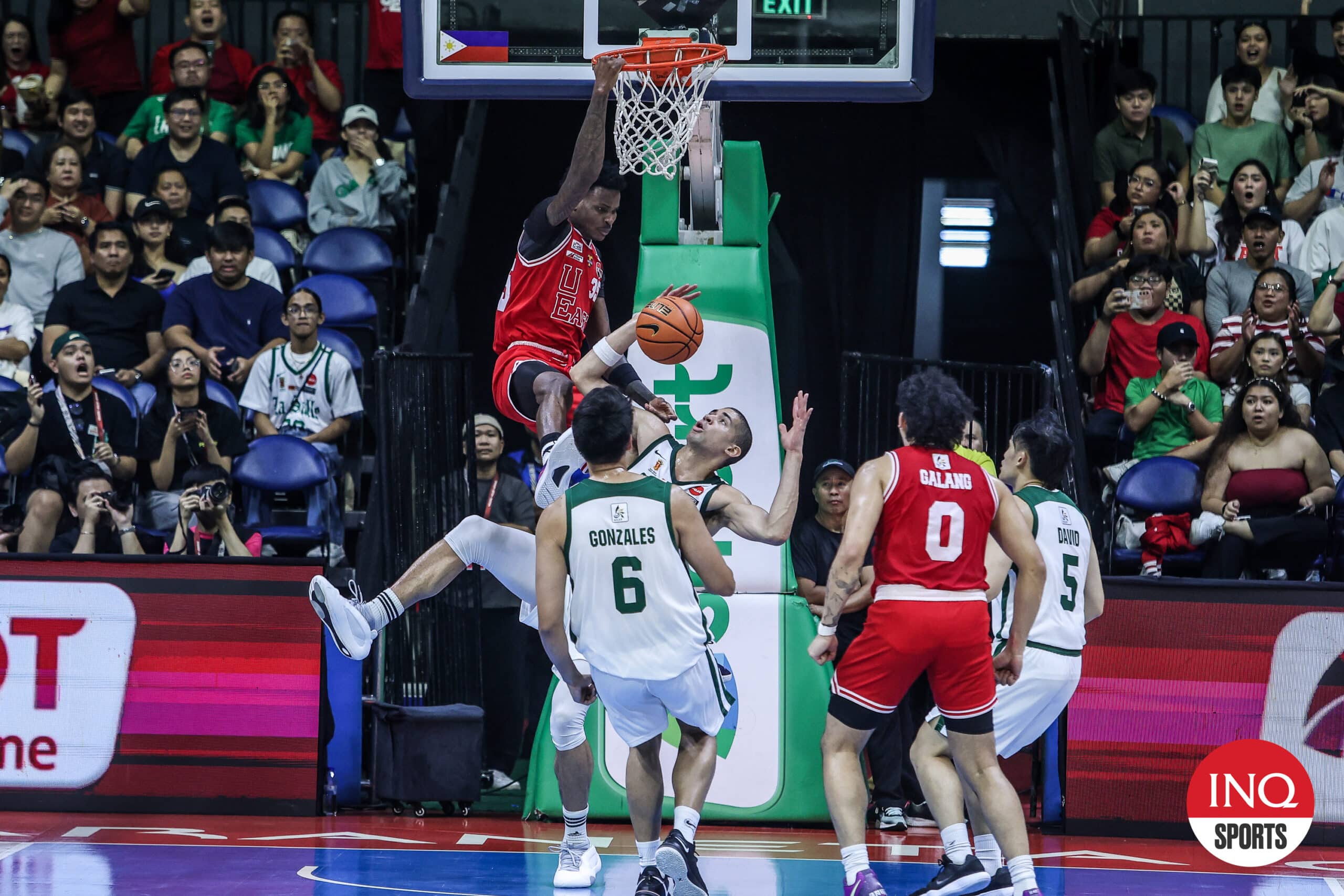 UE Red Warriors' Precious Momowei puts La Salle Green Archers' Mike Phillips on a poster during a UAAP Season 87 men's basketball tournament game. 